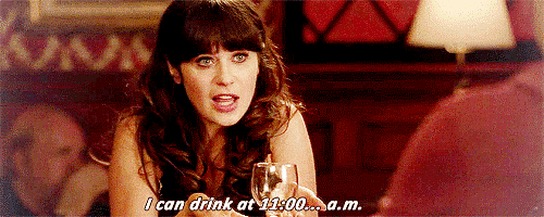a woman is sitting at a table holding a glass of wine and saying i can drink at 11:00 a.m.