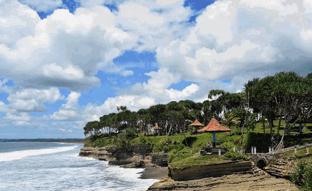 a cliff overlooking the ocean with a gazebo in the middle