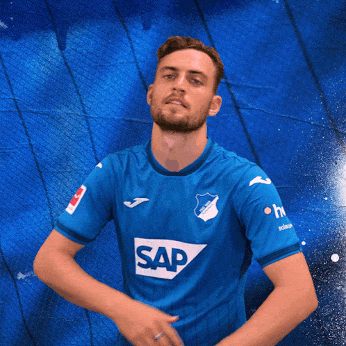 a man wearing a blue shirt with the word sap on the front