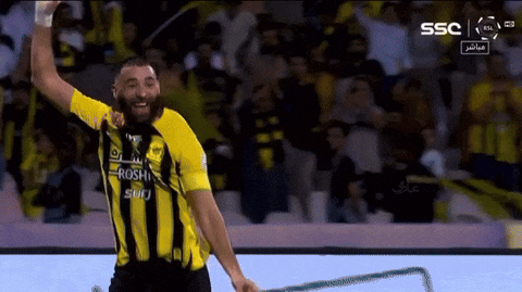 a man wearing a yellow and black striped shirt that says roshi
