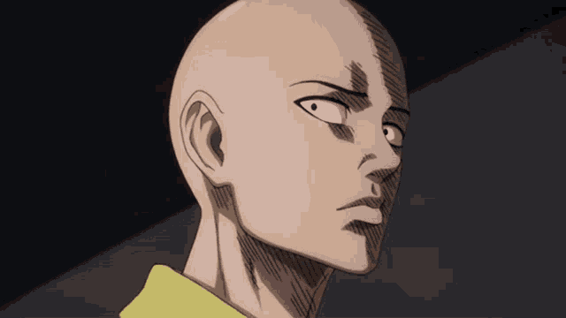 a close up of a man 's head with a yellow shirt on
