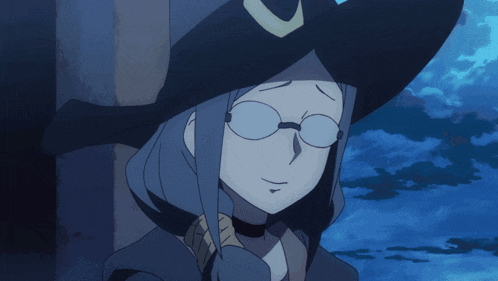 a woman wearing glasses and a witch hat looks sad