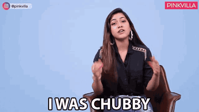 a woman in a black shirt is sitting in a chair and saying i was chubby .