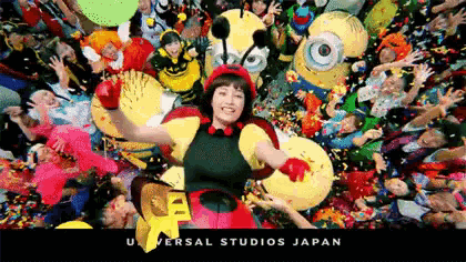 a woman dressed in a bee costume is surrounded by a crowd of people .