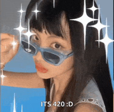a girl wearing sunglasses is taking a selfie and says it 's 420 d