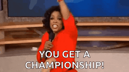 a woman in a red dress is holding a microphone in her hand and says `` you get a championship ! ''