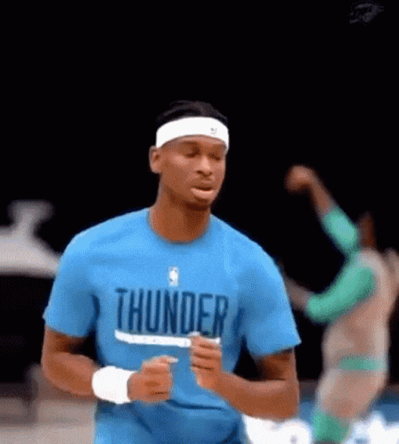 a basketball player wearing a blue shirt that says thunder is running on the court .