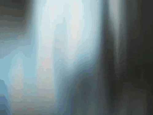 a blurry picture of a window with a light coming through it