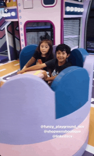 a boy and a girl are riding a roller coaster at a playground called funzy_playground_sev