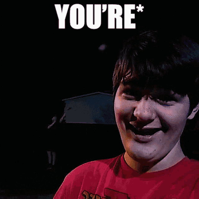 a man in a red shirt is screaming with the word you 're above him