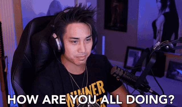a man wearing headphones sits in front of a microphone with the words " how are you all doing " below him