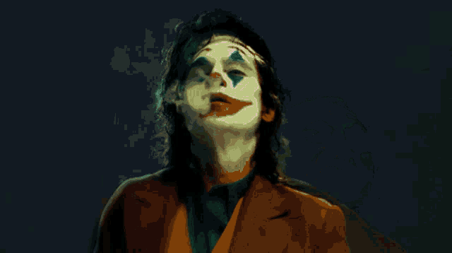 a close up of a man with a joker face painted on his face