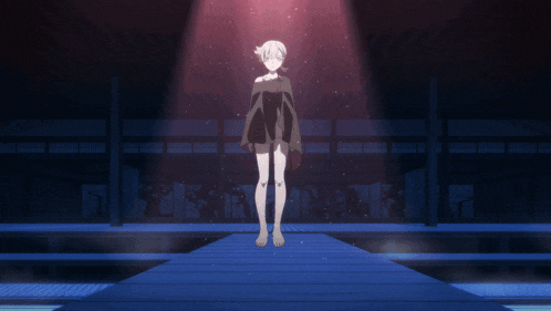 a girl in a black dress is standing on a blue platform