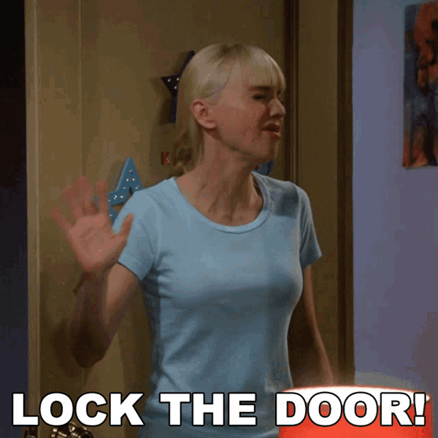 a woman in a blue shirt is standing in front of a door with the words lock the door below her