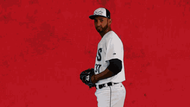 a baseball player with the number 37 on his jersey is about to throw the ball