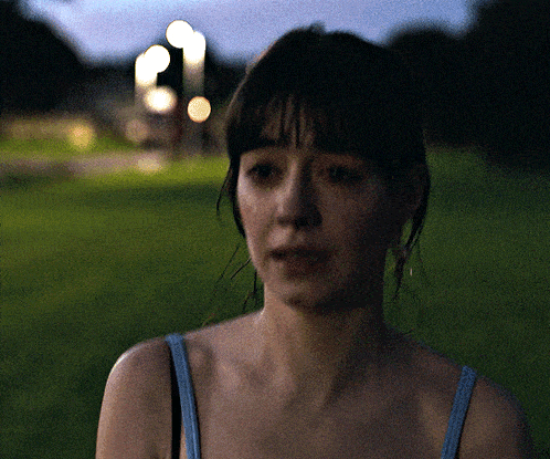 a close up of a woman 's face with a blurry background