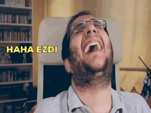 a man with glasses and a beard is laughing with the words " haha ezdi " above him