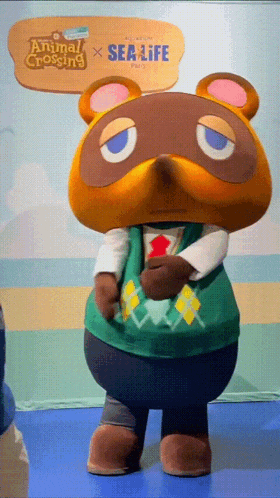 a stuffed animal is standing in front of a sign that says animal crossing and sea life