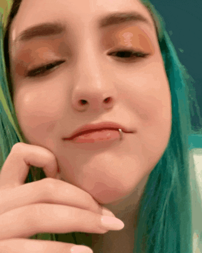 a close up of a woman 's face with a lip piercing