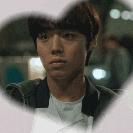 a close up of a man 's face with a heart shaped frame around him