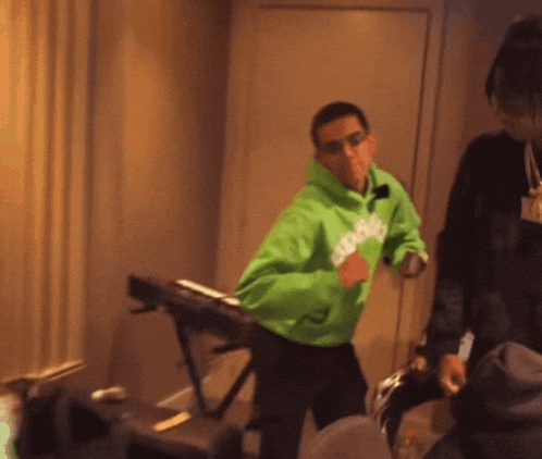 a man wearing a green hoodie that says snoop dogg