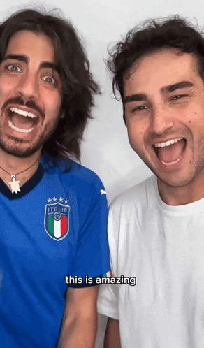 two men are posing for a picture with one wearing an italia jersey