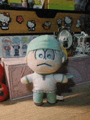 a stuffed doll wearing a green hat and white shirt