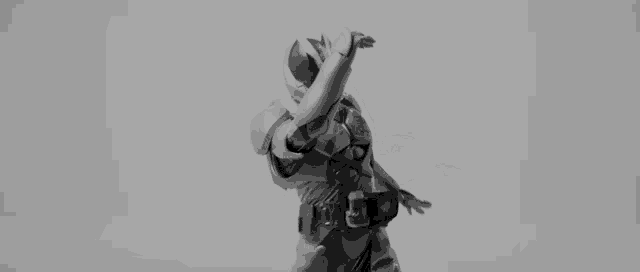 a black and white photo of a person in a superhero costume kicking a ball .