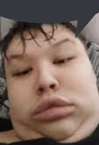 a close up of a person 's face with a speech bubble behind it