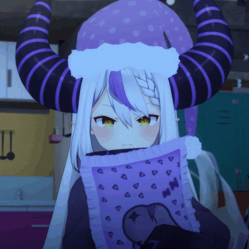 a girl with horns is holding a purple pillow that says mn