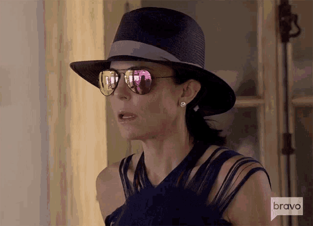 a woman wearing a hat and sunglasses is on bravo television