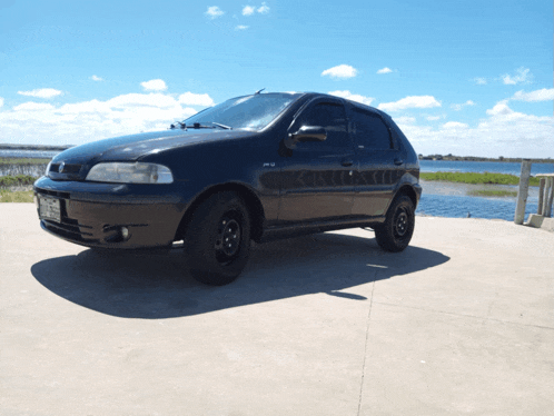 a black car is parked on the side of a road
