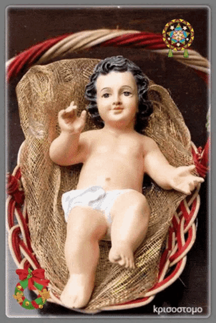 a picture of a baby jesus in a basket with a christmas wreath behind him