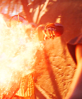a close up of a person holding a fireball in their hand