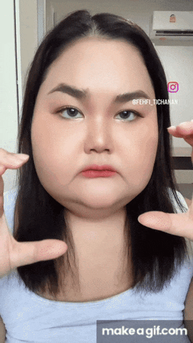 a woman 's face is shown in a make a gif.com video