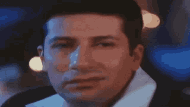 a close up of a man 's face in a dark room