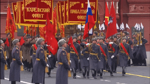 a group of soldiers marching in front of a banner that says karelsky front