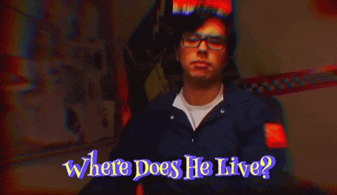 a man with cat ears and glasses says " where does he live "