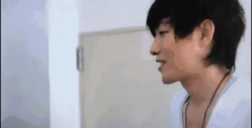 a close up of a man 's face in front of a white door .