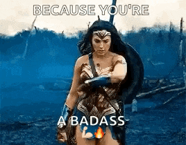 wonder woman is standing in the middle of a field holding a shield and a sword .