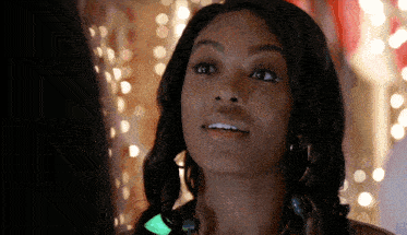 a close up of a woman 's face with a green light in her hair