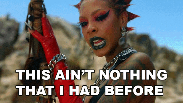 a woman with red gloves is holding a sword with the words this ain 't nothing that i had before below her