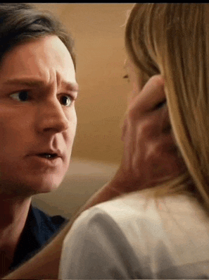 a man and a woman are looking at each other .