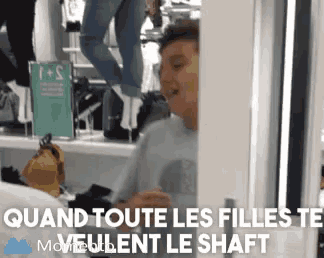 a man is standing in a store with the words " quand toute les filles te veulent le shaft " on the bottom