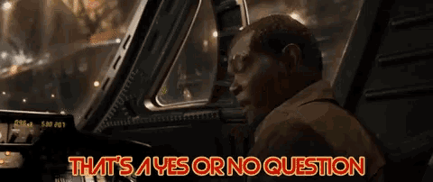 a man is sitting in a car with the words that 's a yes or no question above him