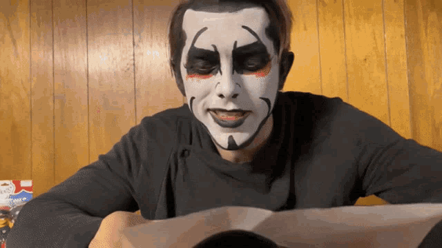 a man with a clown makeup on his face