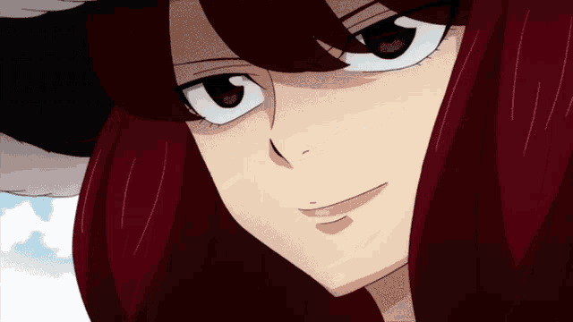 a close up of a woman 's face with red hair and black eyes
