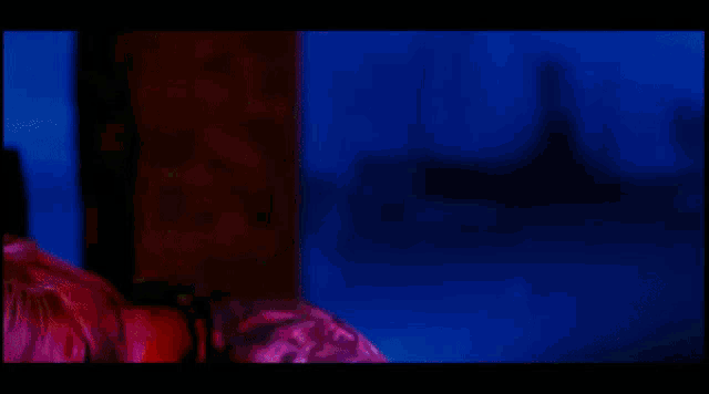 a blurry image of a person playing a guitar in a dark room