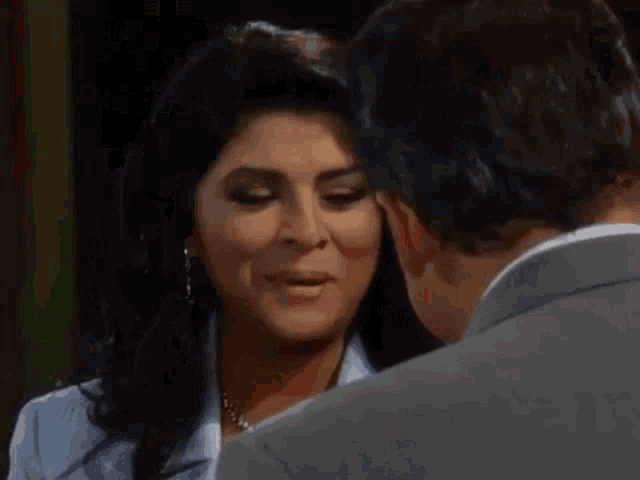 a man and a woman are looking at each other .