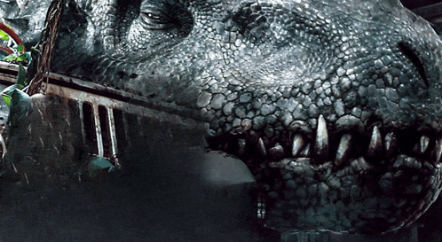 a close up of a dinosaur 's mouth and teeth with a blurred background